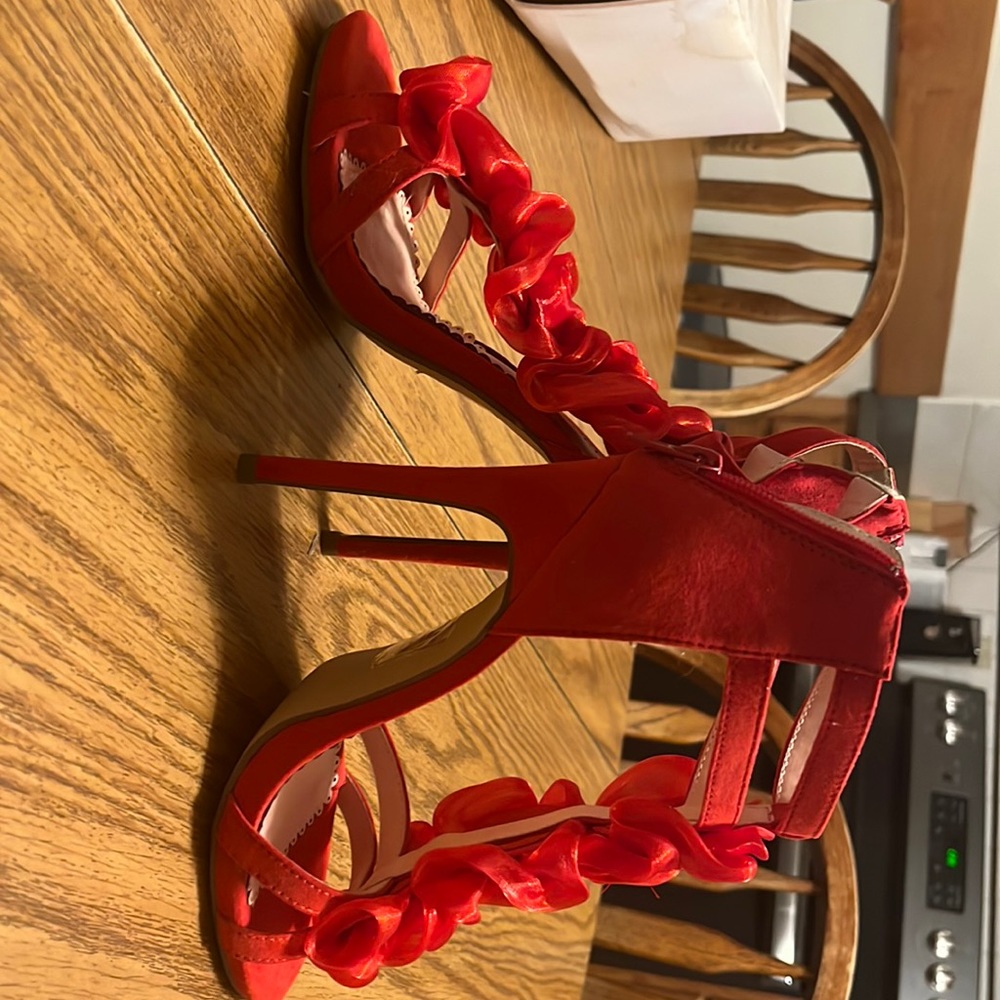 Red satiny heels with roses up front